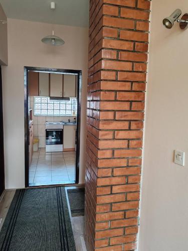 a brick wall in a room with a doorway at City Park Rooms in Vranje