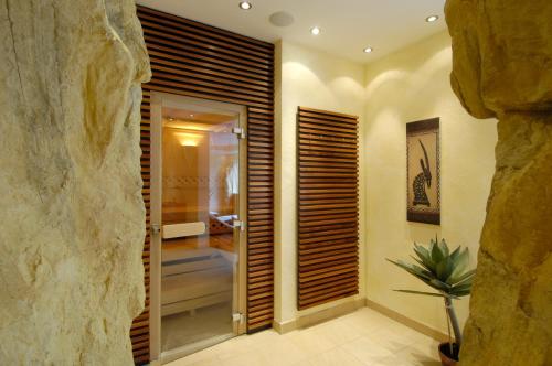 a hallway with a walk in shower and a glass door at Friesachers Aniferhof in Anif