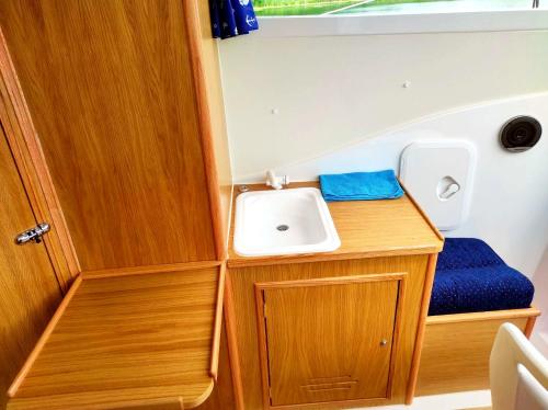 a small bathroom with a sink and a mirror at Jachty, Czartery, Łodzie bez patentu RELAX Ruciane-Nida in Ruciane-Nida