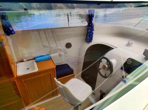 a small boat with a toilet and a sink at Jachty, Czartery, Łodzie bez patentu RELAX Ruciane-Nida in Ruciane-Nida