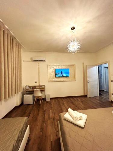 a bedroom with a bed and a desk in a room at EFFE Home in Catania