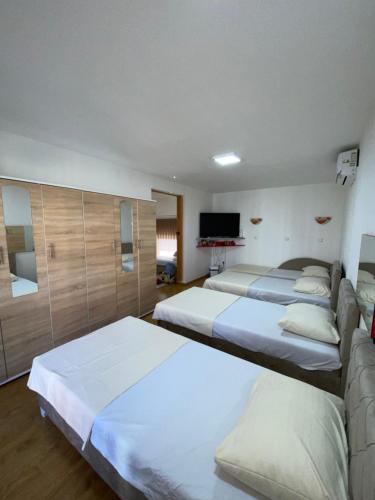 a bedroom with three beds and a couch at Home DINA in Ilidža