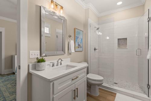 a white bathroom with a sink and a toilet at Time Flys - 498 Baisden Lane in Mallory Park