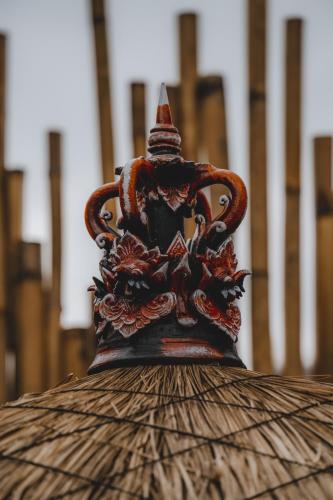 a vase with a hat sitting on top at Nivriti Bali in Sidemen