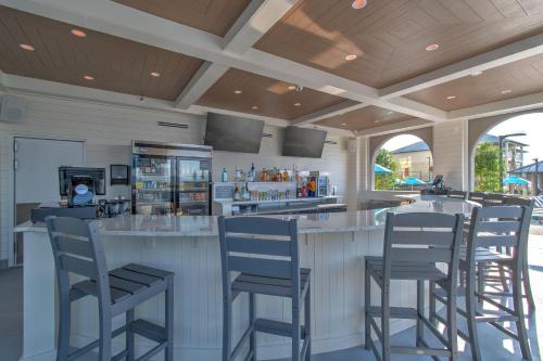 a bar with bar stools in a restaurant at The Oasis at Orange Beach 2006 (Phoenix West II) in Orange Beach