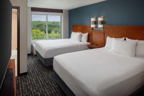 a hotel room with two beds and a window at Hyatt Place Uncasville - Casino Area in Uncasville