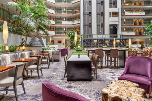 a restaurant with purple chairs and tables at Embassy Suites by Hilton Irvine Orange County Airport in Irvine