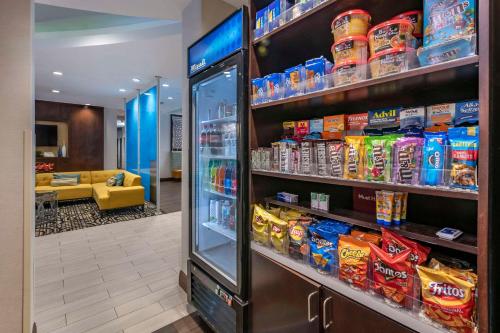 a store with a refrigerator filled with lots of food at Comfort Suites Fort Lauderdale Airport South & Cruise Port in Dania Beach