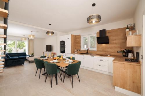 a kitchen and dining room with a table and chairs at CROWONDER Villa Bura with Heated Swimming Pool and Jacuzzi in Privlaka