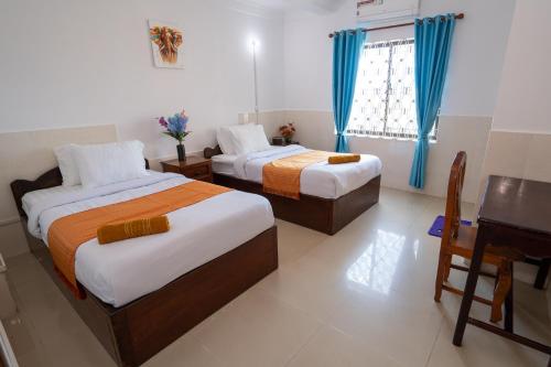 Postel nebo postele na pokoji v ubytování Zen Angkor Guest House