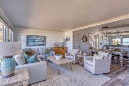 a living room with couches and a dining room at Breakers Beach House 1 - Meredith Lodging in Neskowin