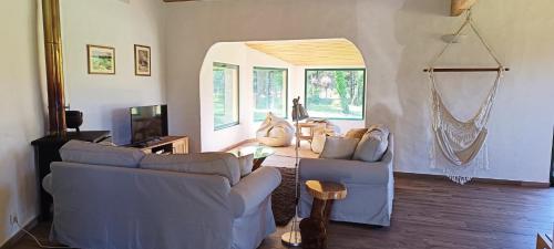 a living room with two blue couches and a mirror at Casa da Mata in Praia de Mira
