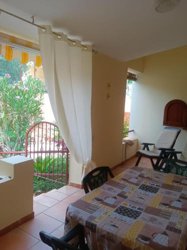 a bedroom with a bed in a room with a window at Vacanze a Solanas con Clima CUP1863 in Solanas