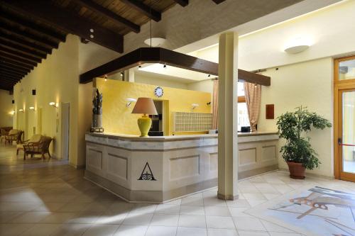 a lobby with a reception counter in a building at Argonauti Greenblu Resort in Marina di Pisticci