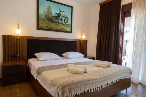 a bedroom with a large bed with two pillows on it at Apartments Milla in Ulcinj