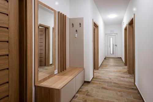 a hallway with wooden floors and white walls at Villa Milutin 1 in Vrsi