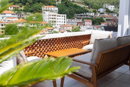 a balcony with a table and chairs and a city at Apartments Milla in Ulcinj