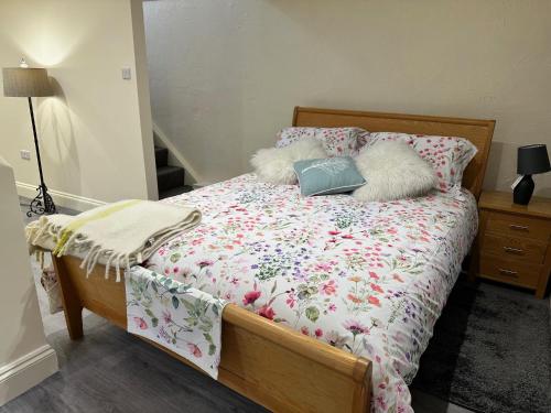 a bed with two pillows and a comforter on it at Taylor & Miller's Maisonette in North Walsham