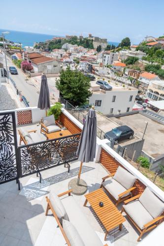 a balcony with umbrellas and a table and chairs at Apartments Milla in Ulcinj