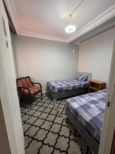 a hotel room with two beds and a chair at Transit 77 in Istanbul