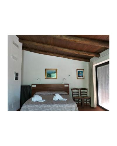 a bedroom with a bed with two towels on it at Il Sogno di Teresa in Camerota