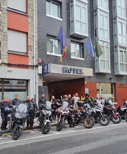 a group of motorcycles parked in front of a hotel at Hotel Ciudad Cangas de Onis in Cangas de Onís