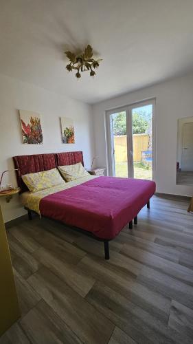 a bedroom with a large bed with a red blanket at Art home relax in Cres