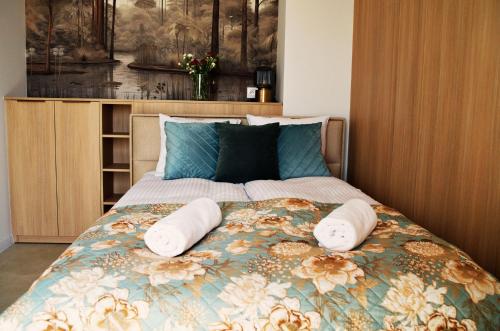 a bedroom with a bed with two pillows on it at Magic Apartments - Siena in Zator