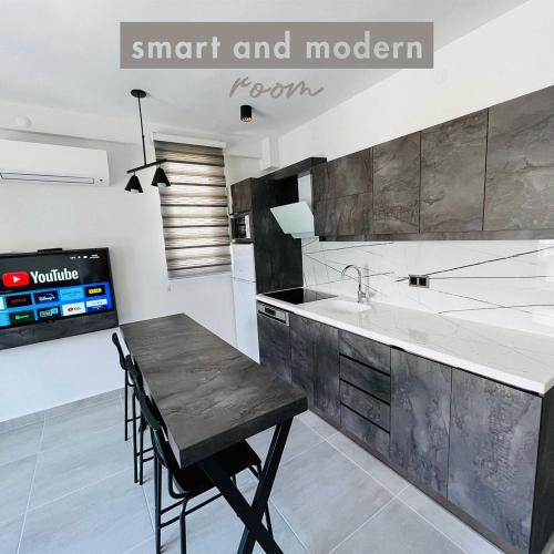 a kitchen with a black table and a sink at EURONOVA HOTEL & SUiTES in Kemer