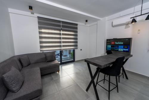 a living room with a couch and a table at EURONOVA HOTEL & SUiTES in Kemer