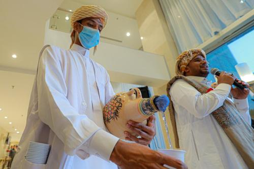 a man wearing a mask and a woman holding a dummy at Nawazi Towers Hotel in Makkah