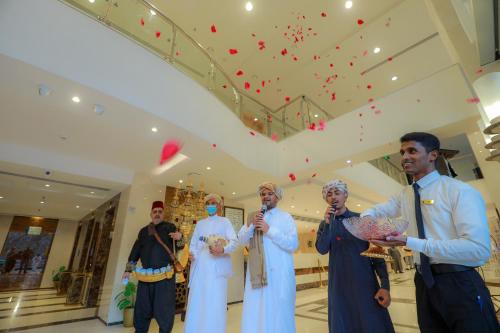 a group of people standing in a lobby at Nawazi Towers Hotel in Makkah