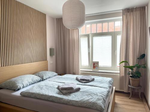 a bedroom with a bed with towels on it at Yutori - Apartment in Malchow