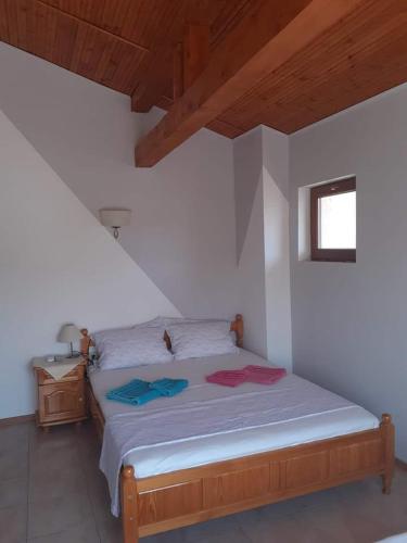 a bedroom with a bed in a white room at Guest House Sun in Kranevo