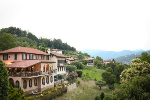 a group of houses on a hill with trees at La Valletta Relais in Bergamo