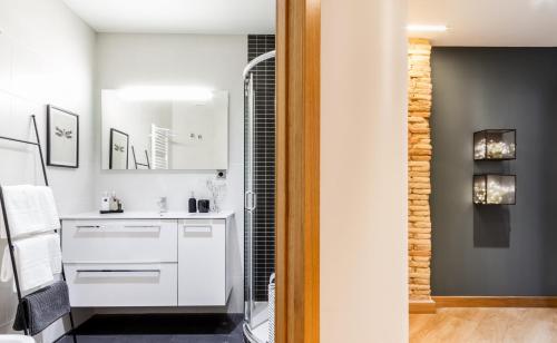 a bathroom with a white sink and a shower at Soul Apartmet in Pamplona
