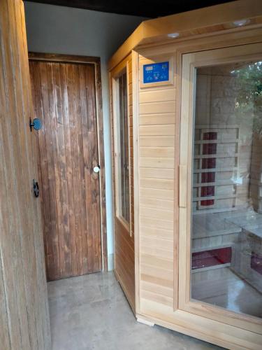 a wooden pivot door in a room with a glass door at Agriturismo Volpignano in Collesano