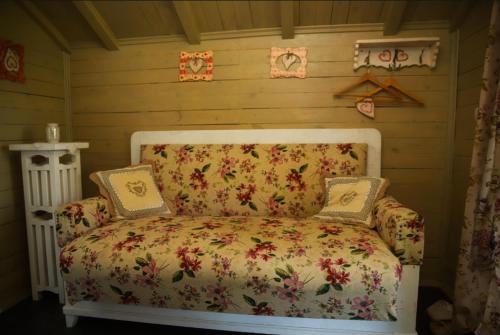 a room with a couch with pillows on it at Pastoral wooden hauses in Velikiy Les