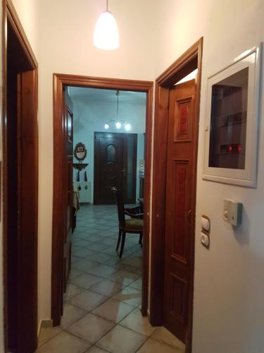 a hallway with a door and a room with a table at HoneyHouse in Kádhion