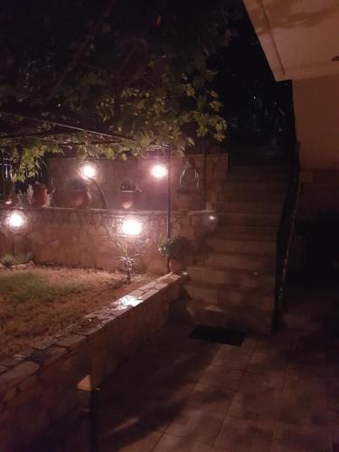 a set of stairs with lights at night at HoneyHouse in Kádhion