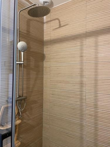 a shower with a glass door in a bathroom at Chai et cuve à vin de 1907 en villa in Ille-sur-Têt