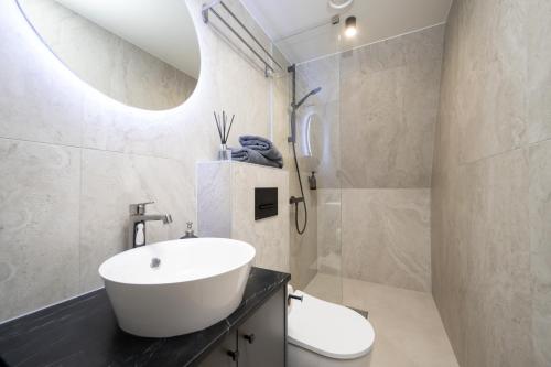 a bathroom with a white sink and a toilet at Pärnu Pearl Residences in Pärnu