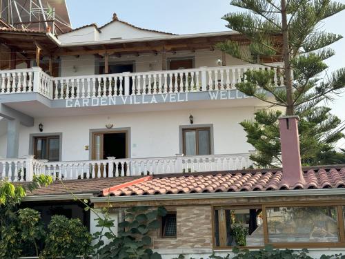 a building with a sign that reads garden villa wellwell at Garden Villa Veli in Ksamil