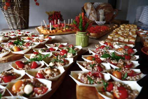 a table topped with lots of food in paper dishes at Agriturismo Cascina Cipressa in San Romano
