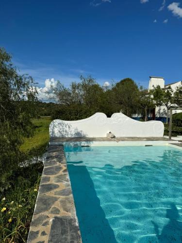 a swimming pool with blue water in a yard at Herdade das Pintas in Monforte