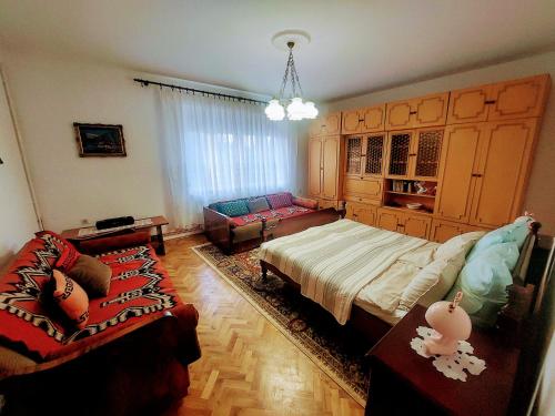 a bedroom with a bed and a couch at Zorica House Vrbas in Vrbas
