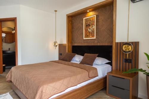 a bedroom with a bed with a wooden headboard at Apartments Milla in Ulcinj