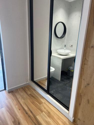 a bathroom with a mirror and a sink at Relax Stay in Ksamil