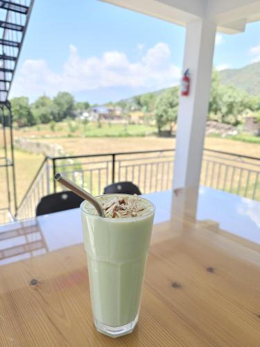 a drink sitting on a table on a porch at The Bunksters Bir in Bīr