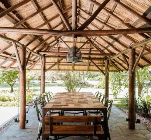 a wooden table and chairs under a wooden pavilion at Verdi Lodge in Lusaka